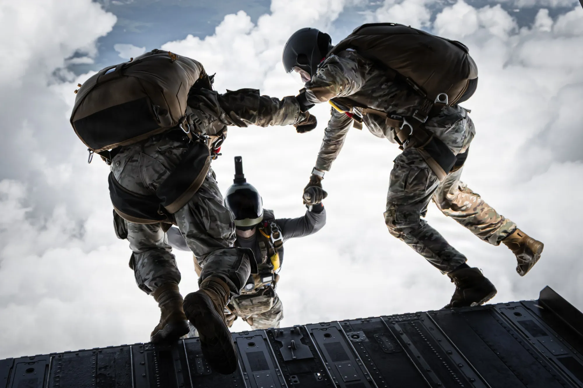 Two Green Berets stepping off an aircraft ramp on a high-altitude, low-opening parachute jump